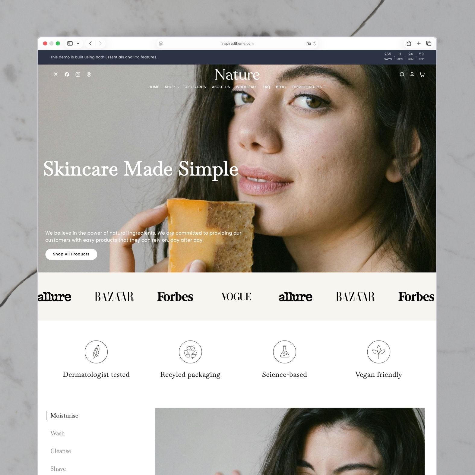 Nature Shopify theme homepage for a natural skincare and soap brand with navy and white tones, hero image of a woman holding an artisan soap bar with 'Skincare Made Simple' headline, press logos marquee, and trust badges for dermatologist-tested and vegan-friendly