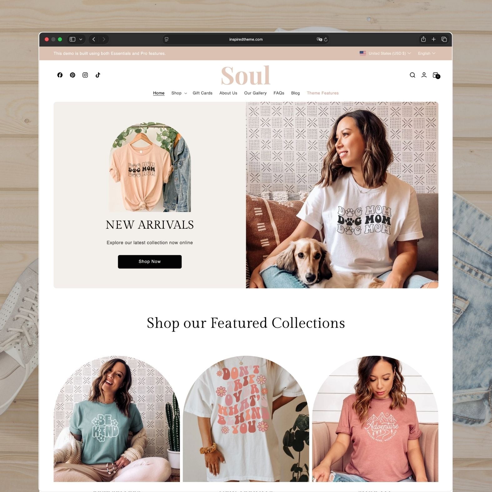 Soul Shopify theme homepage for a graphic tee and women's casual wear brand with warm peach and pink tones, hero section showing 'Dog Mom' graphic tees with 'New Arrivals' banner, featured collections with fun illustrated designs, and cozy lifestyle photography