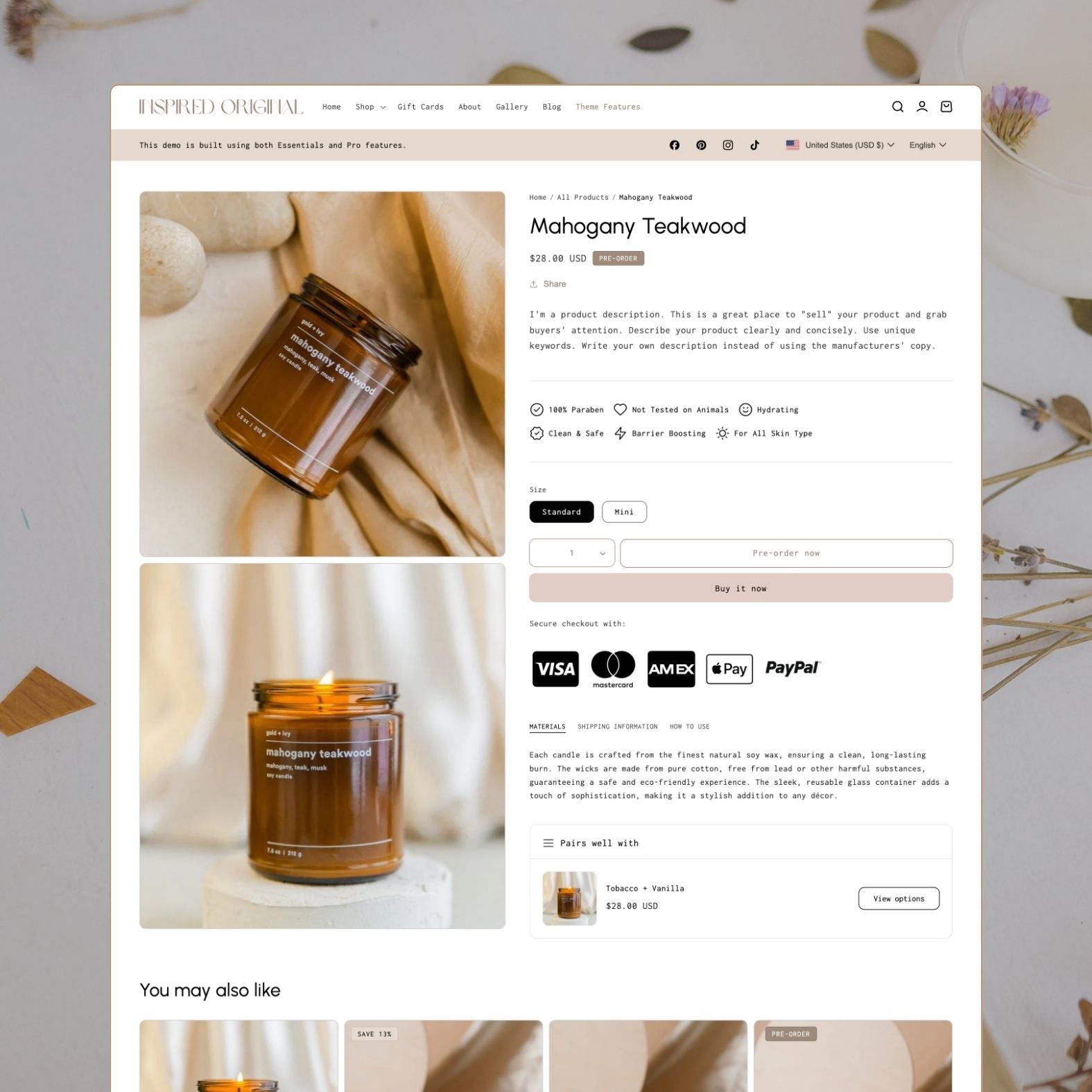 Original theme product page displaying a Mahogany Teakwood soy candle in amber jar with size options, trust badges for paraben-free and not tested on animals, payment icons, 'Pairs well with' upsell section, and product tabs