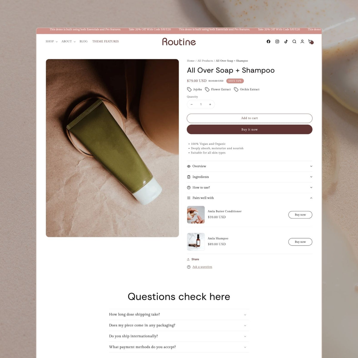 Routine theme product page displaying an All Over Soap + Shampoo in olive green tube with jojoba and flower extract tags, sale badge, vegan and organic benefits, 'Pairs well with' upsell, and FAQ accordion section