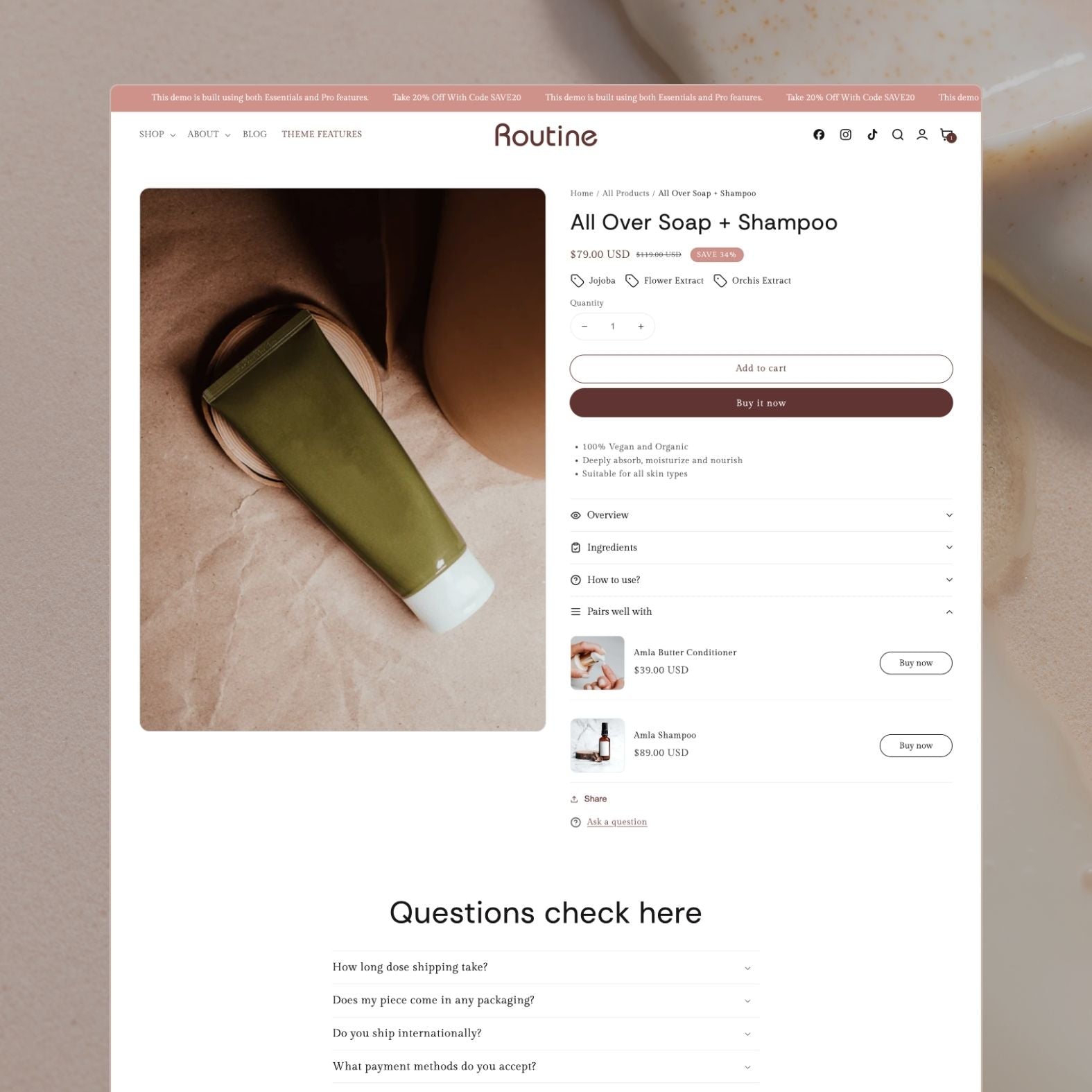 Routine theme product page displaying an All Over Soap + Shampoo in olive green tube with jojoba and flower extract tags, sale badge, vegan and organic benefits, 'Pairs well with' upsell, and FAQ accordion section